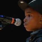 child in front of microphone