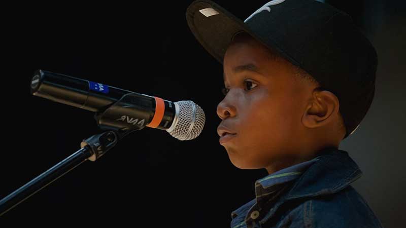 child in front of microphone