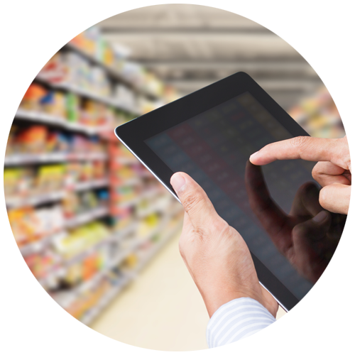 Circle with a hand holding a tablet with grocery store aisle in background