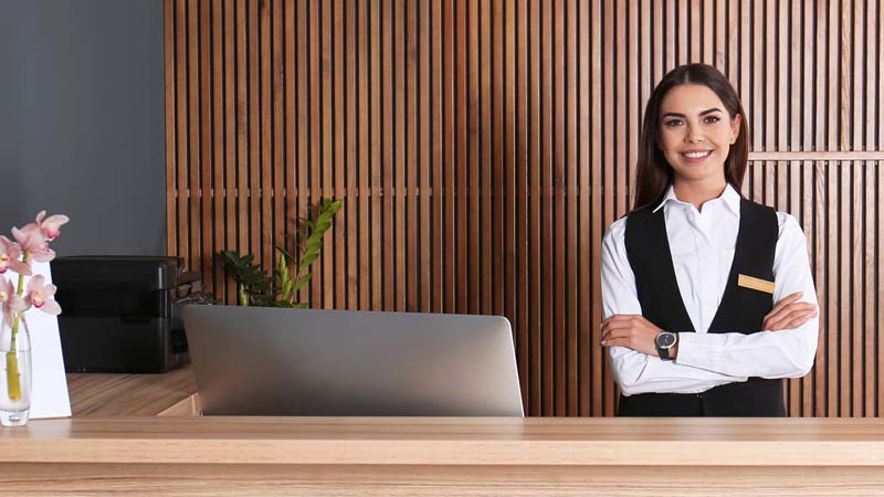 Employee at hotel or restaurant front desk