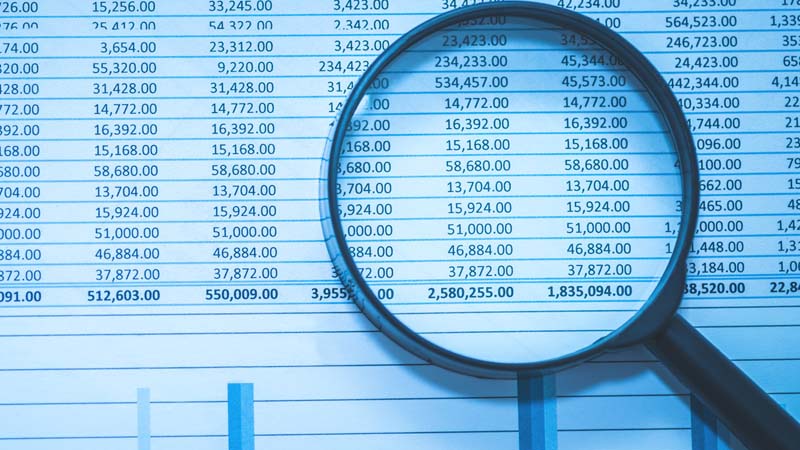 Magnifying glass on financial report