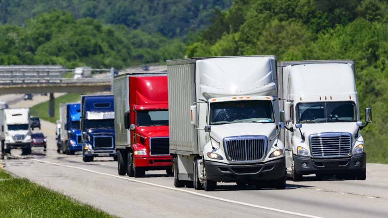 Tractor trailer trucks driving on road