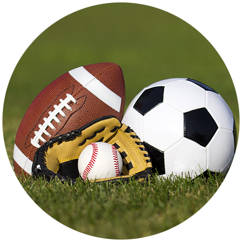 football soccer ball and baseball glove on grass