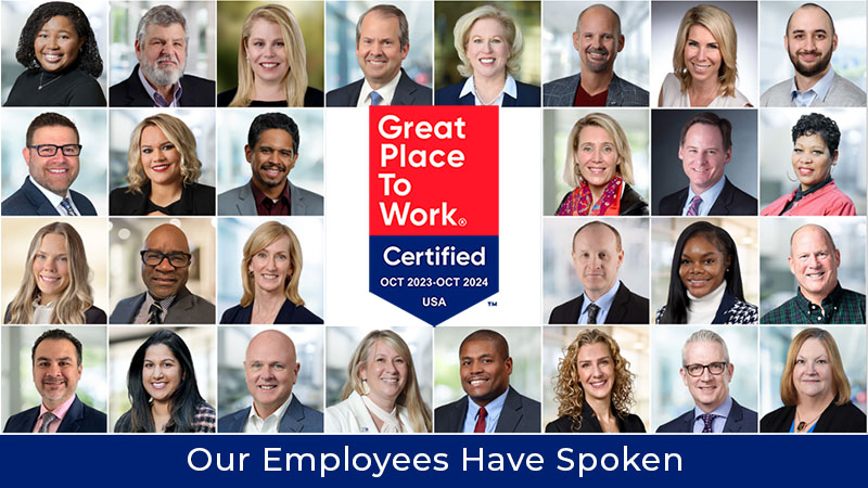 employees surrounding Great Place to Work badge