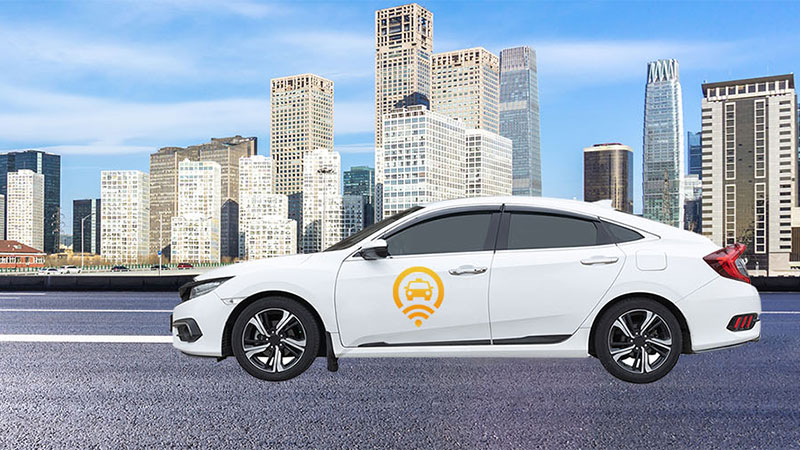 Rideshare car in front of cityscape