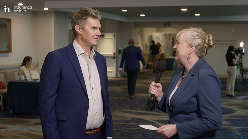 Woman interviewing man at conference